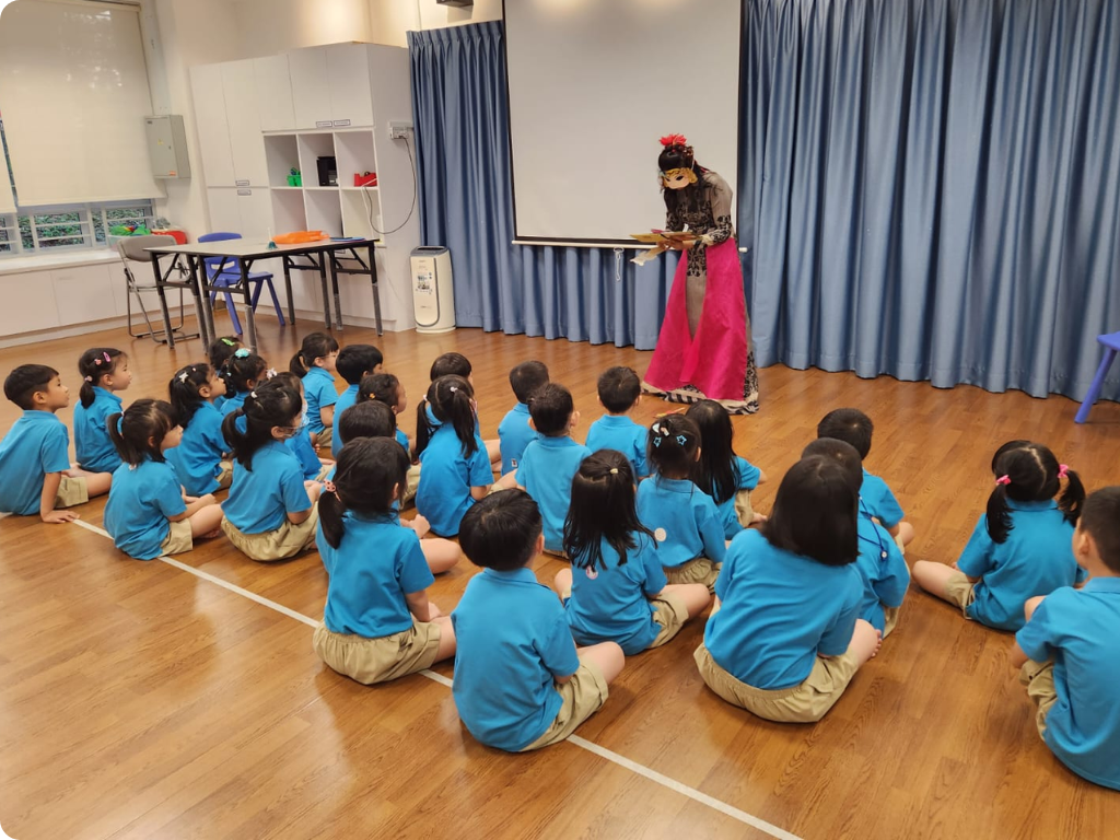 MOE Kindergarten children enjoy an interactive storytelling performance that encourages imagination and participation.
